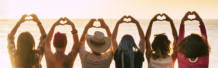 Six people making heart shapes with their hands