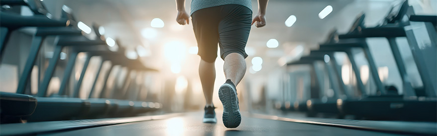 person walking between rows of treadmills